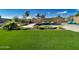 Spacious backyard with a pool, lounge chairs, and vibrant green turf at 2308 E Dry Wood Rd, Phoenix, AZ 85024