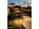 Lush landscaped backyard with unique lighting and decorative garden art, creating a serene ambiance at 2308 E Dry Wood Rd, Phoenix, AZ 85024