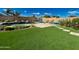 Lush backyard with a pool, lounge chairs, and artificial turf at 2308 E Dry Wood Rd, Phoenix, AZ 85024
