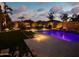 Expansive landscaped backyard with pool, fire features, lush lawn and inviting ambiance at 2308 E Dry Wood Rd, Phoenix, AZ 85024