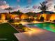 Backyard with a pool, fire pit, and lush landscaping, perfect for outdoor entertaining at 2308 E Dry Wood Rd, Phoenix, AZ 85024