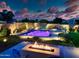 Picturesque backyard featuring a pool, a fire pit, and meticulously manicured landscaping at 2308 E Dry Wood Rd, Phoenix, AZ 85024