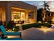 The covered patio overlooks the lush turf and backyard, complete with outdoor kitchen and comfortable seating at 2308 E Dry Wood Rd, Phoenix, AZ 85024