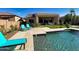 Inviting backyard featuring a sparkling pool, lush greenery, and a covered patio for outdoor relaxation and entertaining at 2308 E Dry Wood Rd, Phoenix, AZ 85024