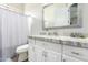 A serene bathroom featuring a granite countertop, modern fixtures, and a convenient shower curtain for privacy at 2308 E Dry Wood Rd, Phoenix, AZ 85024