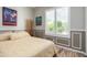 Sunlit bedroom with warm tones, a comfortable bed, and wainscoting, offering a cozy and inviting space at 2308 E Dry Wood Rd, Phoenix, AZ 85024