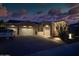 Stunning exterior view featuring a three-car garage, stone accents, desert landscaping, and a welcoming driveway at 2308 E Dry Wood Rd, Phoenix, AZ 85024