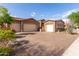 Spacious home with a large driveway, three-car garage, and stone accents, offering ample parking and curb appeal at 2308 E Dry Wood Rd, Phoenix, AZ 85024
