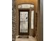 Close-up of the decorative glass front door featuring an artistic glass design with stone accents at 2308 E Dry Wood Rd, Phoenix, AZ 85024