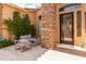 Inviting front porch with stone pillars, a seating area, and lush greenery, creating a welcoming entrance at 2308 E Dry Wood Rd, Phoenix, AZ 85024