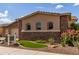 Charming home exterior with stone accents, desert landscaping, and a well-manicured lawn, creating curb appeal at 2308 E Dry Wood Rd, Phoenix, AZ 85024