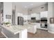 Bright, modern kitchen with white cabinets, stainless steel appliances, and beautiful stone countertops at 2308 E Dry Wood Rd, Phoenix, AZ 85024