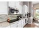 Modern kitchen featuring white cabinetry, stainless steel appliances, and stone countertops at 2308 E Dry Wood Rd, Phoenix, AZ 85024