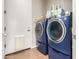 Modern laundry room featuring front-load washer and dryer units and ample storage space for laundry essentials at 2308 E Dry Wood Rd, Phoenix, AZ 85024