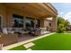 Comfortable covered patio featuring a cozy seating area, outdoor dining, and a built-in grill at 2308 E Dry Wood Rd, Phoenix, AZ 85024
