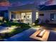Covered patio with comfortable seating, a fire pit, and a view of the landscaped backyard at 2308 E Dry Wood Rd, Phoenix, AZ 85024