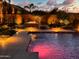 Luxurious pool with a fire pit and beautiful night lighting, creating a serene oasis at 2308 E Dry Wood Rd, Phoenix, AZ 85024