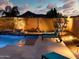 Relaxing poolside with cozy lounge chairs in this tranquil backyard setting. Warm evening lighting at 2308 E Dry Wood Rd, Phoenix, AZ 85024
