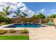 Lush backyard featuring desert landscaping, a rock waterfall and an inviting pool, perfect for outdoor relaxation at 2308 E Dry Wood Rd, Phoenix, AZ 85024