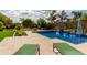 Beautiful pool featuring clear blue water, rock waterfall and a lush landscaped yard, perfect for outdoor relaxation at 2308 E Dry Wood Rd, Phoenix, AZ 85024