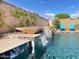 Stunning pool with modern water features and travertine tile, creating a luxurious outdoor oasis at 2308 E Dry Wood Rd, Phoenix, AZ 85024