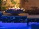 Poolside fire bowls provide a gorgeous nighttime ambiance in this stunning backyard at 2308 E Dry Wood Rd, Phoenix, AZ 85024