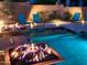 Tranquil pool with dual fire pits, illuminated in vibrant blue tones for a relaxing night swim at 2308 E Dry Wood Rd, Phoenix, AZ 85024