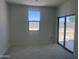 Bright bedroom with sliding glass doors and backyard views, perfect for relaxation at 24104 W Bowker St, Buckeye, AZ 85326