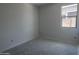 Empty bedroom with natural light streaming in from a window, providing a relaxing atmosphere at 24104 W Bowker St, Buckeye, AZ 85326