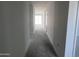 A view down a long hallway in the interior of a home at 24104 W Bowker St, Buckeye, AZ 85326