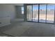 Sun-filled living room showcasing large sliding glass doors that open to the outdoor area at 24104 W Bowker St, Buckeye, AZ 85326