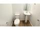 Cozy powder room features pedestal sink, tiled floor, and modern fixtures, offering style and functionality at 25133 W Wayland Dr, Buckeye, AZ 85326