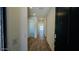 Inviting hallway with luxury vinyl plank flooring and recessed lighting, leading to various rooms in the home at 25133 W Wayland Dr, Buckeye, AZ 85326