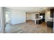 Bright and open concept living space with luxury vinyl plank flooring, recessed lighting and seamless transition to kitchen at 25133 W Wayland Dr, Buckeye, AZ 85326
