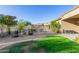 Nicely landscaped backyard featuring lush grass, desert landscape, and comfortable outdoor seating at 26330 N 56Th Dr, Phoenix, AZ 85083
