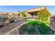 Well-maintained yard featuring a grassy area, desert landscaping, and outdoor seating at 26330 N 56Th Dr, Phoenix, AZ 85083