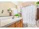 Bathroom with a vanity sink, a decorative mirror, and a shower with a white curtain at 26330 N 56Th Dr, Phoenix, AZ 85083