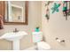 Powder room with a pedestal sink, and a decorative mirror that enhances the room's appeal at 26330 N 56Th Dr, Phoenix, AZ 85083