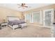 Primary bedroom featuring carpeted floors, a ceiling fan, and plenty of natural light at 26330 N 56Th Dr, Phoenix, AZ 85083