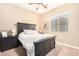 Bedroom with a black bed frame, a ceiling fan, and a window that provides natural light at 26330 N 56Th Dr, Phoenix, AZ 85083