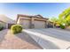 Three-car garage with desert landscaping at 26330 N 56Th Dr, Phoenix, AZ 85083