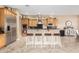 Modern kitchen features stainless steel appliances and an eat-in island with barstool seating at 26330 N 56Th Dr, Phoenix, AZ 85083