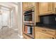Gourmet kitchen featuring stainless steel double ovens and granite countertops at 26330 N 56Th Dr, Phoenix, AZ 85083