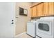 Laundry room equipped with modern machines and ample cabinet space for storage at 26330 N 56Th Dr, Phoenix, AZ 85083