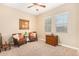 Cozy living room with leather chairs, a ceiling fan, and natural light from windows at 26330 N 56Th Dr, Phoenix, AZ 85083