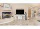 Inviting living area features a cozy fireplace and a stylish entertainment center at 26330 N 56Th Dr, Phoenix, AZ 85083