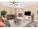 Inviting living room boasts a cozy fireplace, neutral tones, and comfortable seating arrangement at 26330 N 56Th Dr, Phoenix, AZ 85083
