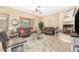 Spacious living room featuring neutral color scheme, a ceiling fan, and a charming fireplace at 26330 N 56Th Dr, Phoenix, AZ 85083