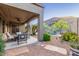 Inviting covered patio with stylish seating overlooks the sparkling pool and landscaped backyard at 26330 N 56Th Dr, Phoenix, AZ 85083