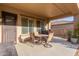 Covered patio with a dining table, seating area, and view of the surrounding landscape at 26330 N 56Th Dr, Phoenix, AZ 85083
